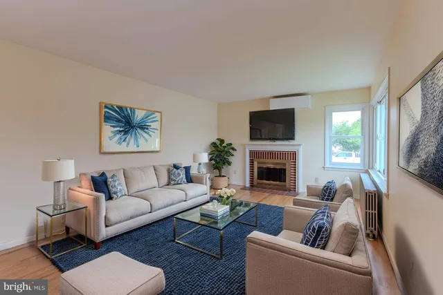 a living room with furniture a window and a fireplace