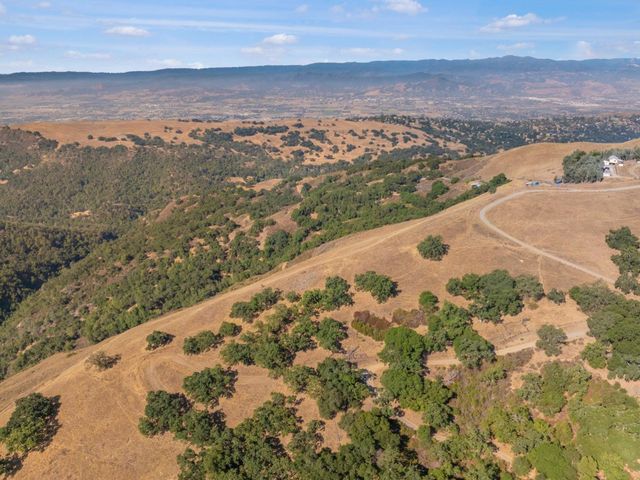 a view of a dry yard with a mountain