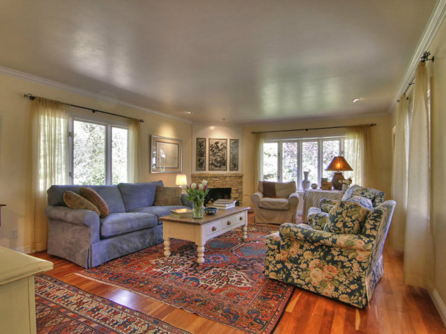 25064 Hatton Road Carmel, CA 93923 - Photo 13 of 25 a living room with furniture fireplace and a window