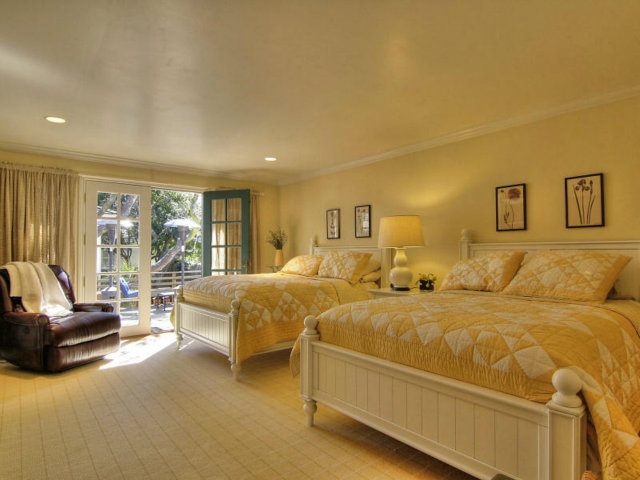 25064 Hatton Road Carmel, CA 93923 - Photo 17 of 25 a spacious bedroom with a bed and glass window