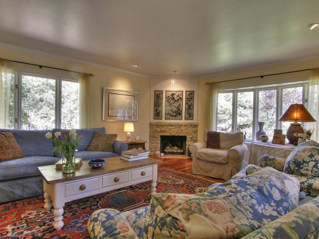 25064 Hatton Road Carmel, CA 93923 - Photo 5 of 25 a living room with furniture large window and a fireplace