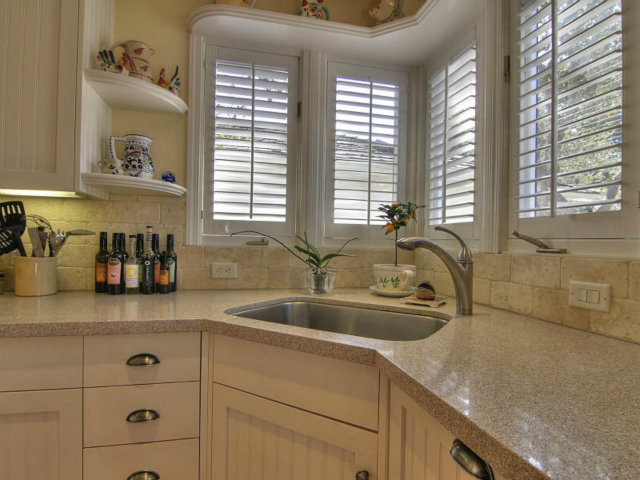 25064 Hatton Road Carmel, CA 93923 - Photo 7 of 25 a kitchen with sink a window and cabinets