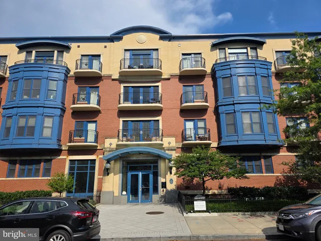 a front view of a residential apartment building with a yard