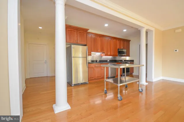 a kitchen with stainless steel appliances a refrigerator and a stove top oven