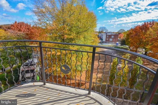 a view of balcony with wooden floor and fence
