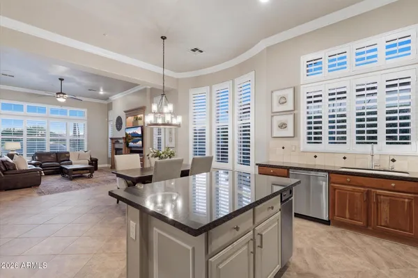 a kitchen with granite countertop a sink and a stove