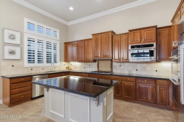 a kitchen that has a sink and a stove in it