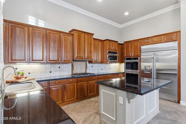 a kitchen with stainless steel appliances granite countertop a sink stove and refrigerator