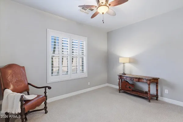 a bedroom with a large bed and a flat tv screen