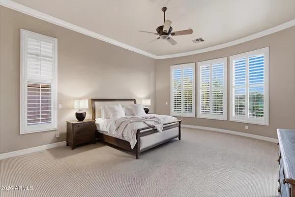 a bedroom with a bed chair and a window