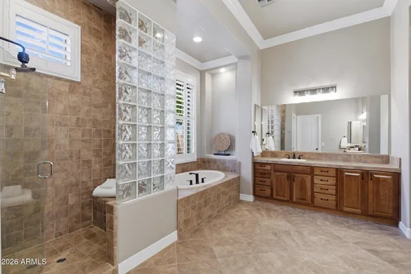 a en suite bathroom with a double vanity sink and a mirror