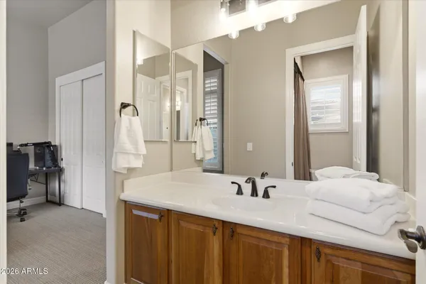 a bathroom with a sink a toilet and a mirror