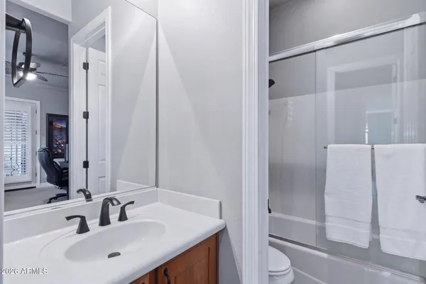 a kitchen with stainless steel appliances granite countertop a sink a stove and a refrigerator with wooden cabinets