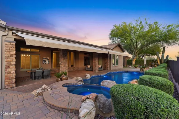 a view of a swimming pool with sitting area