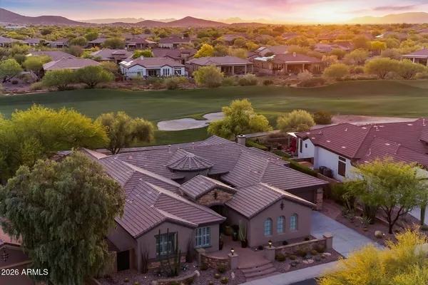 an aerial view of residential houses with outdoor space and trees