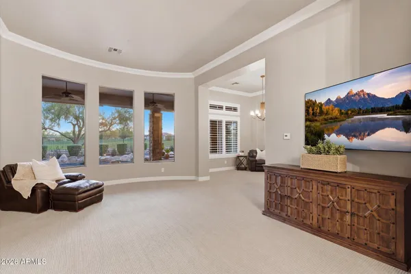 a spacious bedroom with furniture and a large window