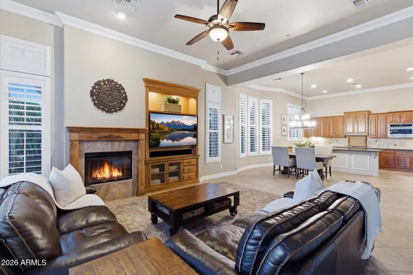 a living room with furniture a fireplace and a chandelier