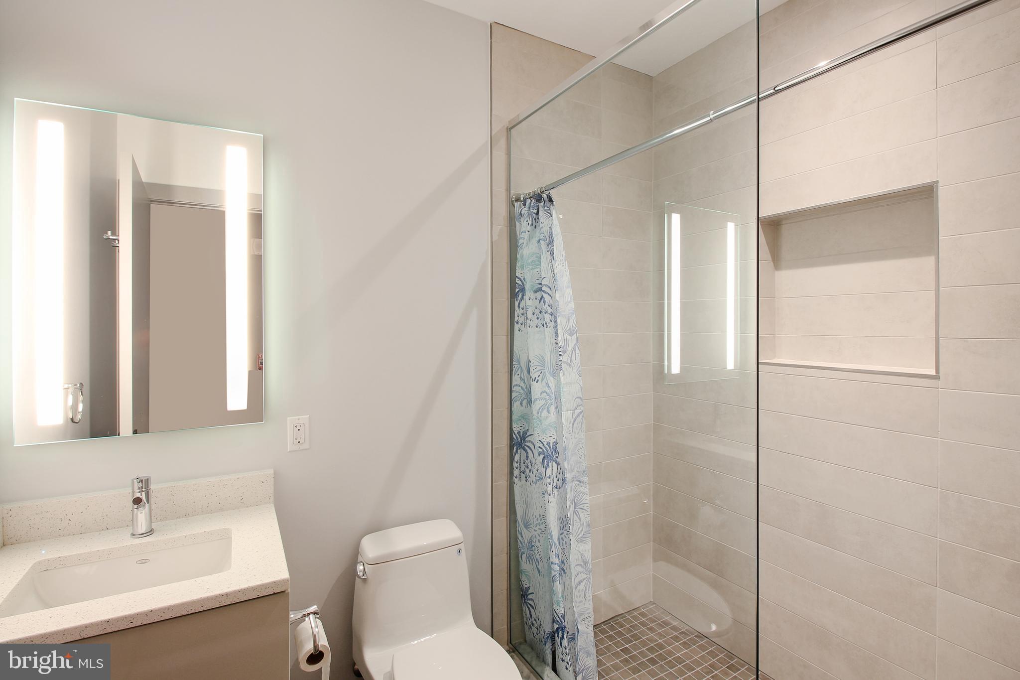 448 K Street Northwest, Unit 202 Washington, DC 20001 - Photo 18 of 25 a bathroom with a shower a sink and toilet