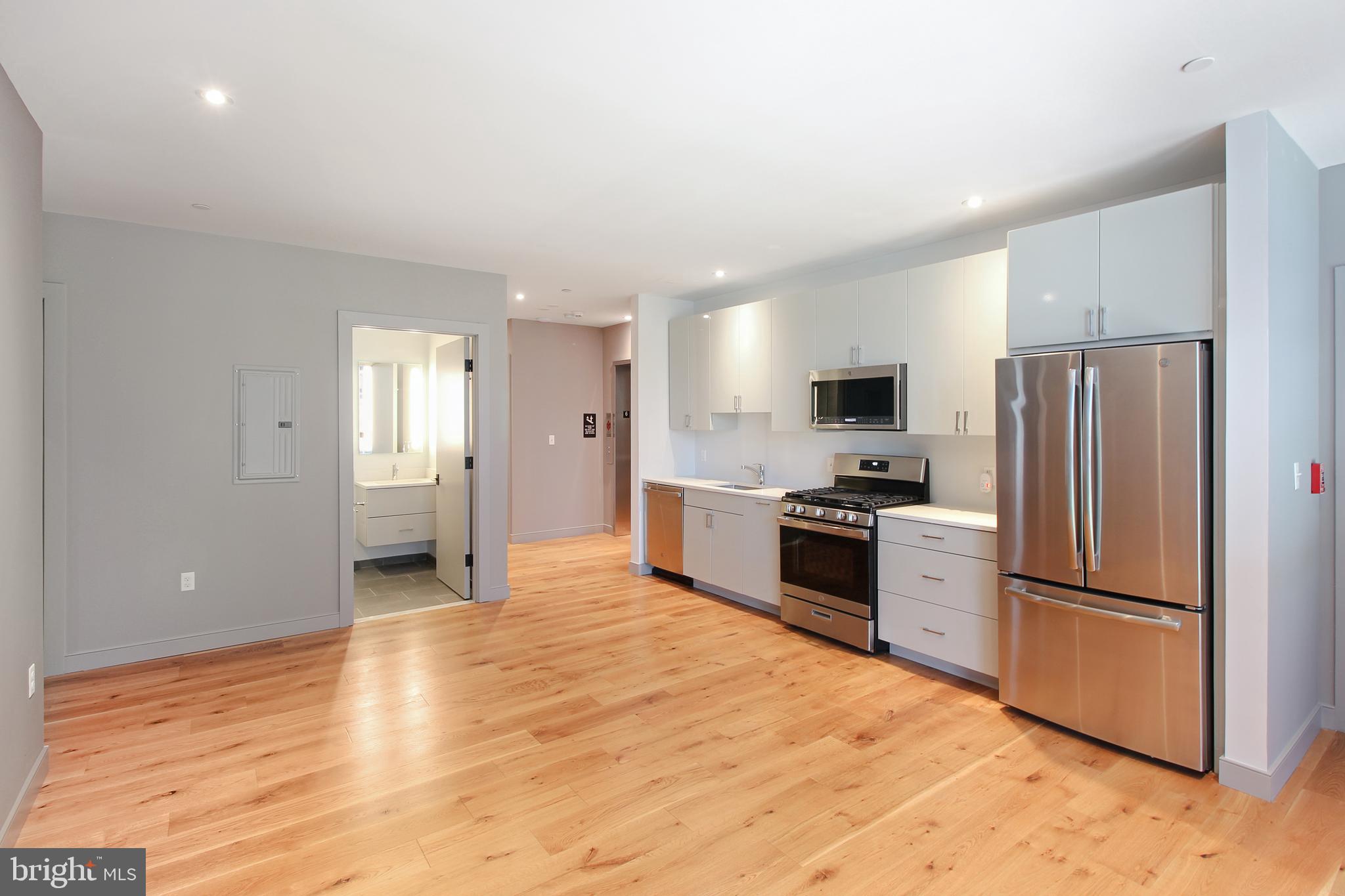 448 K Street Northwest, Unit 202 Washington, DC 20001 - Photo 8 of 25 a kitchen with stainless steel appliances a refrigerator stove and microwave