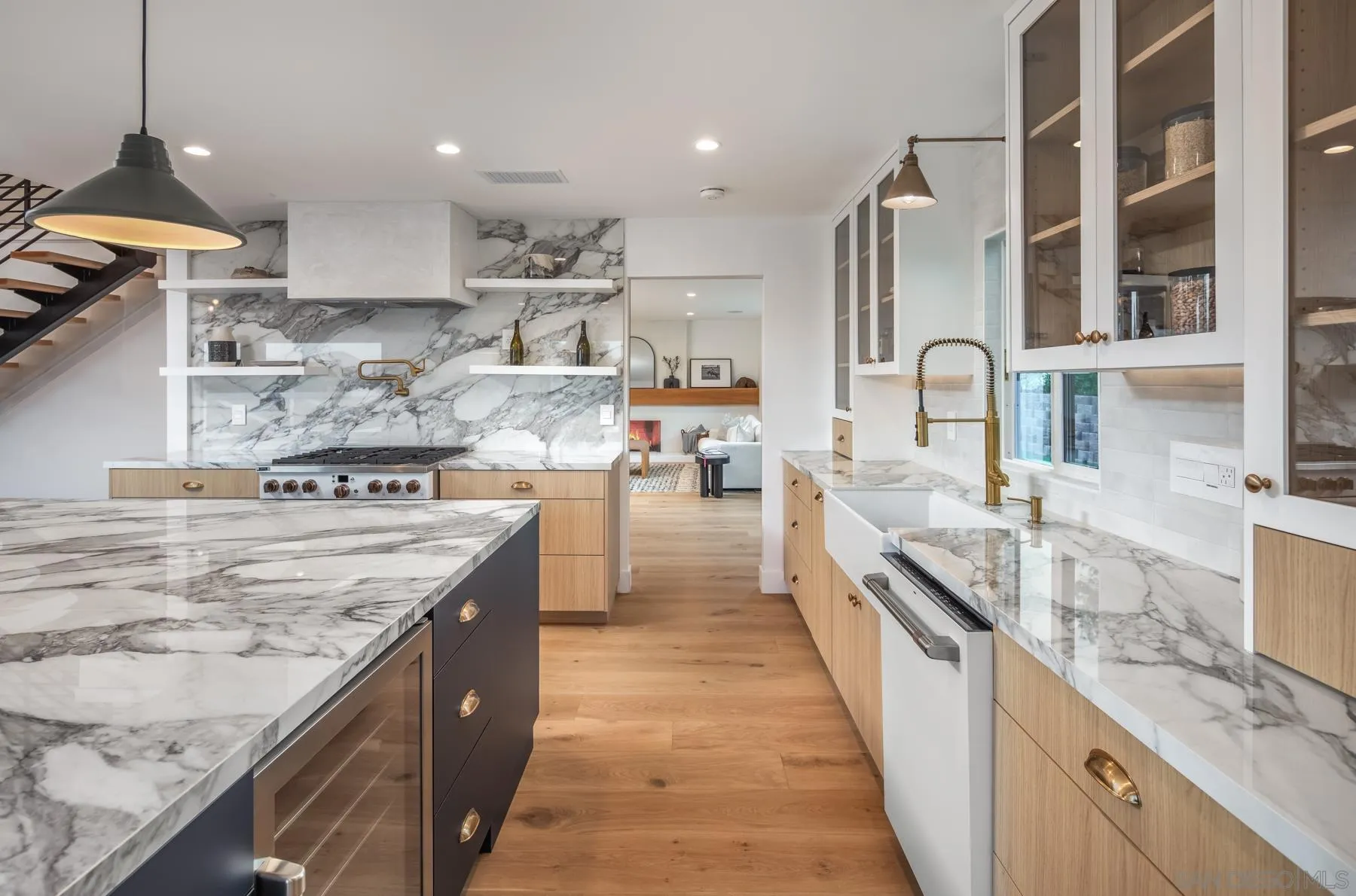 2125 Woodwind Drive Encinitas, CA 92024 - Photo 1 of 33 a large kitchen with stainless steel appliances granite countertop a lot of counter space and wooden floors