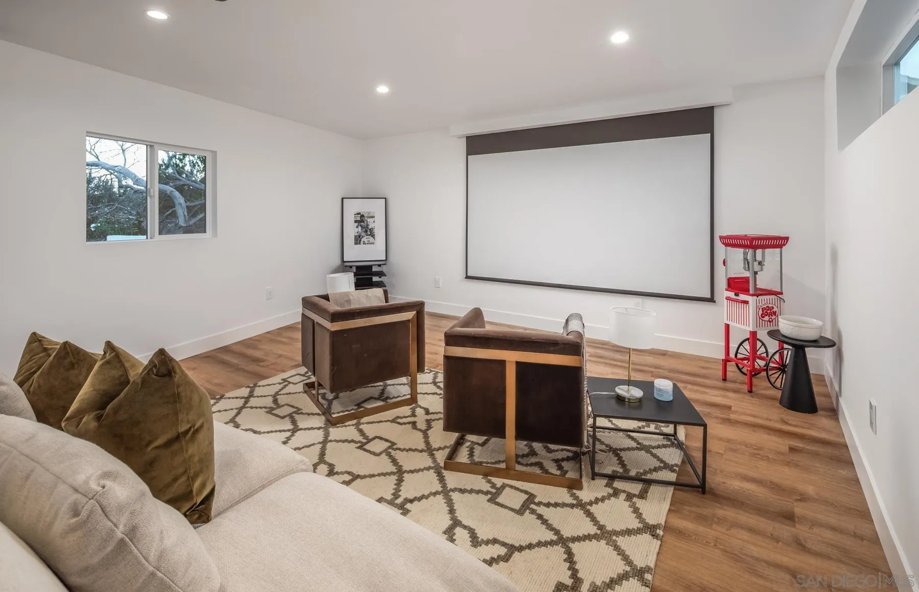 2125 Woodwind Drive Encinitas, CA 92024 - Photo 22 of 33 a living room with furniture a flat screen tv and a table