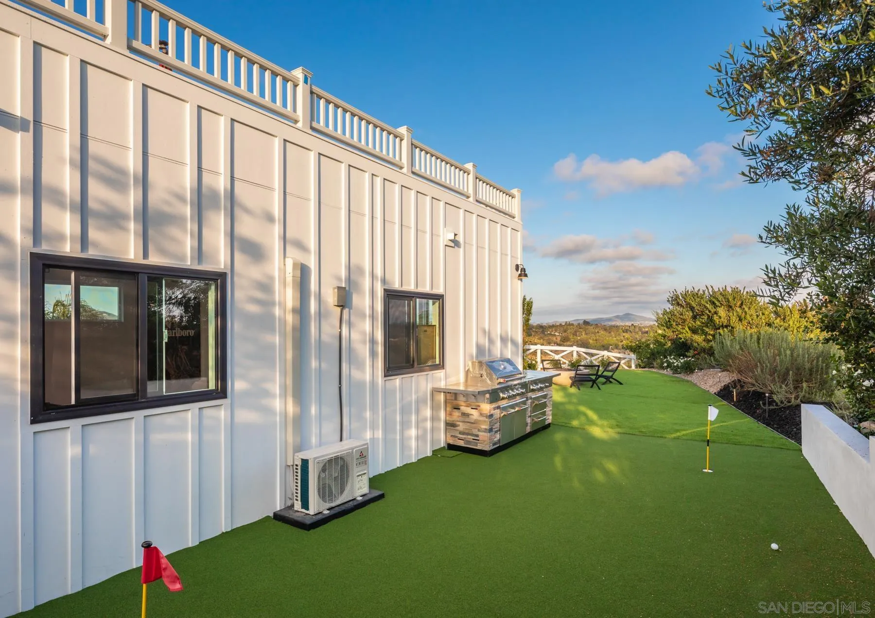 2125 Woodwind Drive Encinitas, CA 92024 - Photo 25 of 33 a backyard of a house with table and chairs