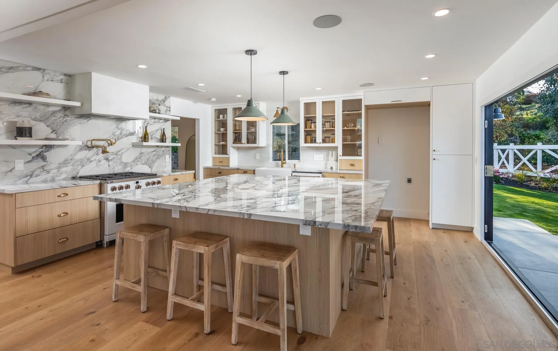 2125 Woodwind Drive Encinitas, CA 92024 - Photo 6 of 33 a kitchen with kitchen island granite countertop a table chairs sink and cabinets