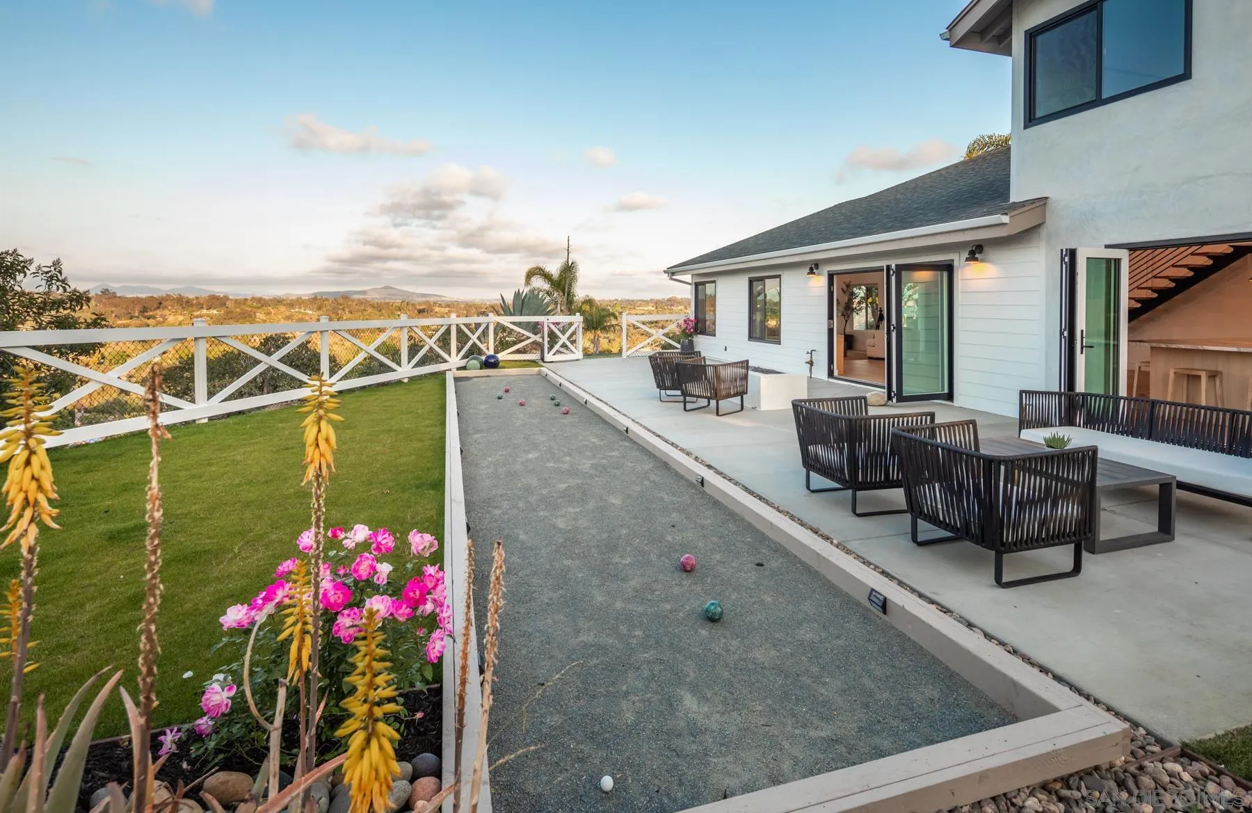 2125 Woodwind Drive Encinitas, CA 92024 - Photo 9 of 33 a view of a patio with couches potted plants and a floor to ceiling window