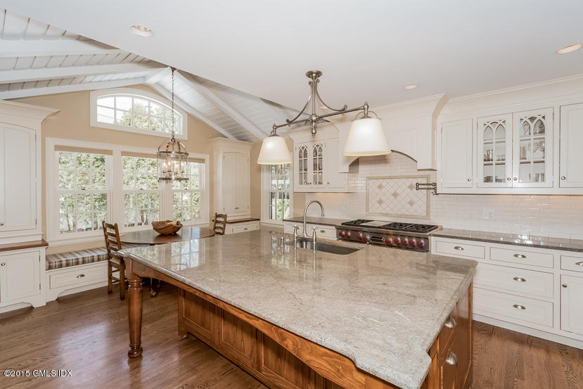 11 Owenoke Way Riverside, CT 06878 - Photo 23 of 61 a kitchen with stainless steel appliances granite countertop a sink stove and wooden floor