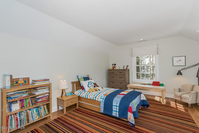 11 Owenoke Way Riverside, CT 06878 - Photo 47 of 61 a bedroom with furniture and a book shelf