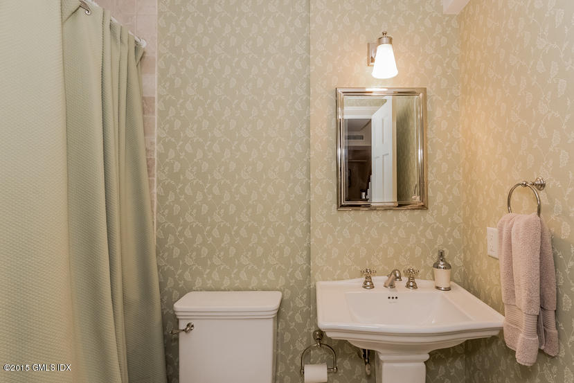 11 Owenoke Way Riverside, CT 06878 - Photo 54 of 61 a bathroom with a sink a toilet and mirror
