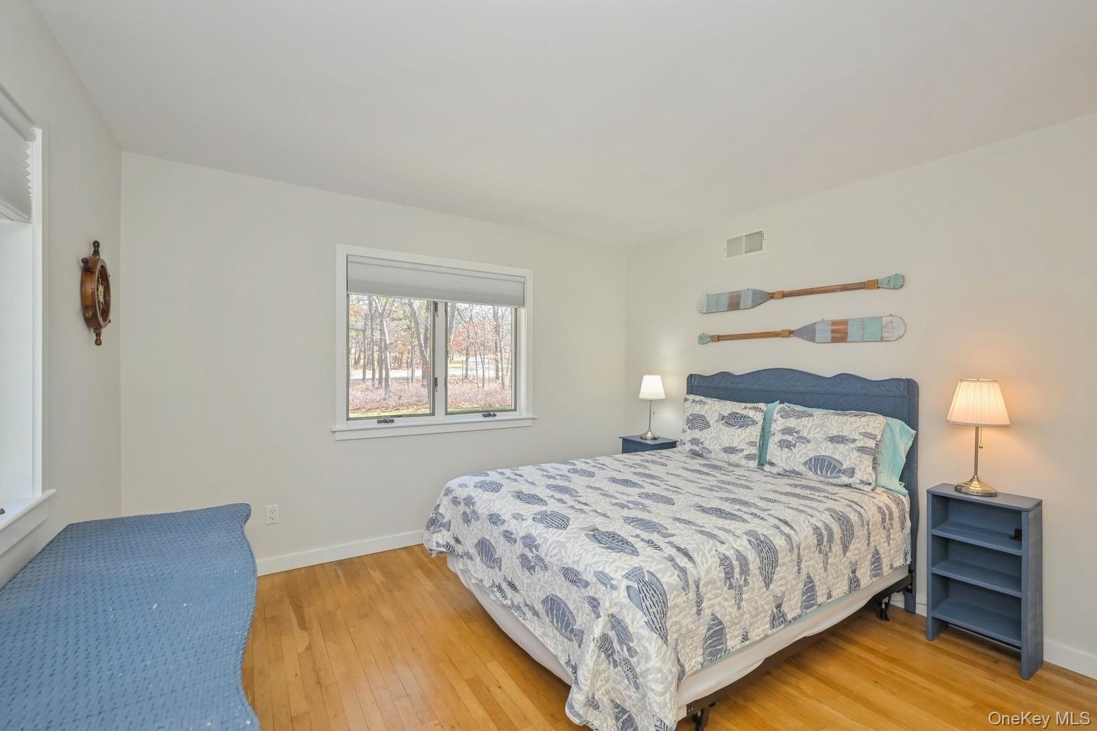 16 Hildreth Road Hampton Bays, NY 11946 - Photo 23 of 29 a bedroom with a bed and a lamp