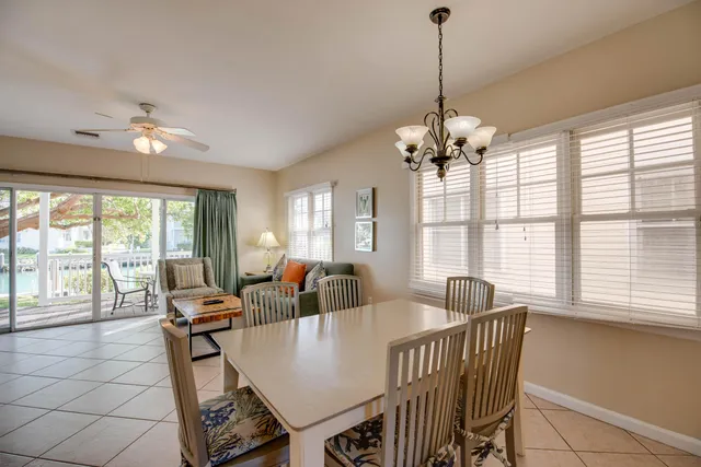a view of a dining room with furniture large windows and wooden floor