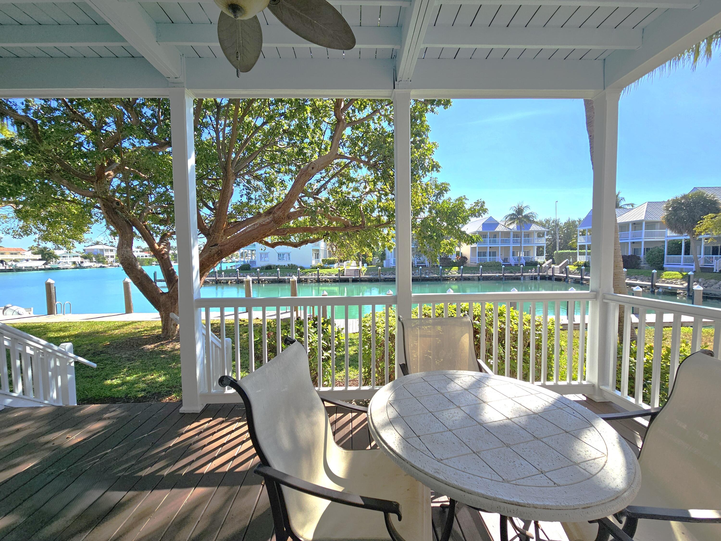 7073 Hawks Cay Boulevard Marathon, FL 33050 - Photo 16 of 50 a view of balcony with wooden floor and outdoor seating