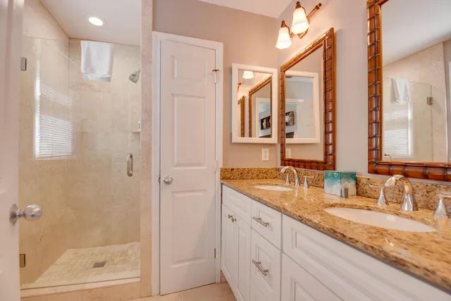 a bathroom with a granite countertop sink mirror and double