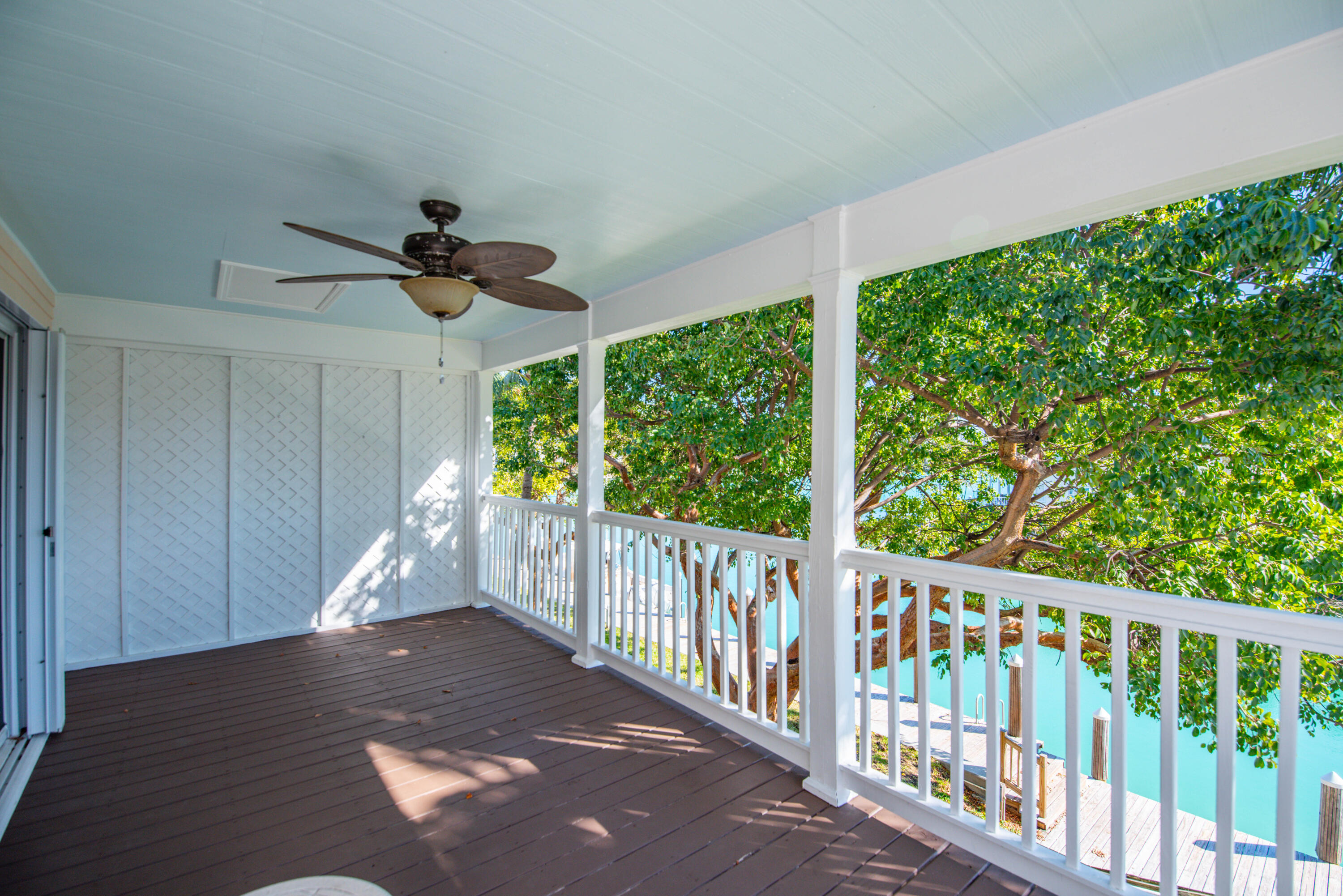 7073 Hawks Cay Boulevard Marathon, FL 33050 - Photo 36 of 50 a view of a porch with wooden floor and outdoor space