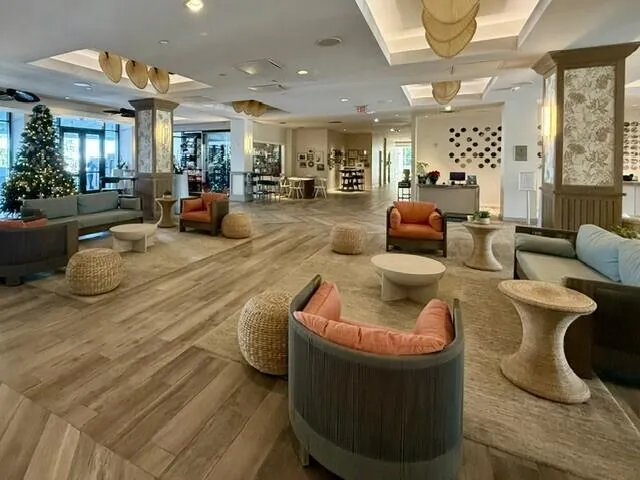 a living room with furniture and a large mirror