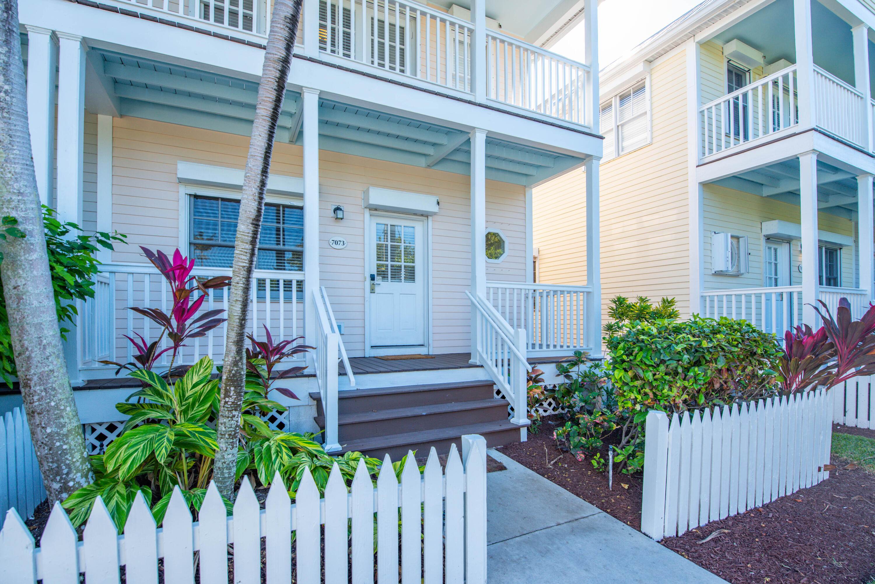 7073 Hawks Cay Boulevard Marathon, FL 33050 - Photo 7 of 50 a front view of a house with a garden