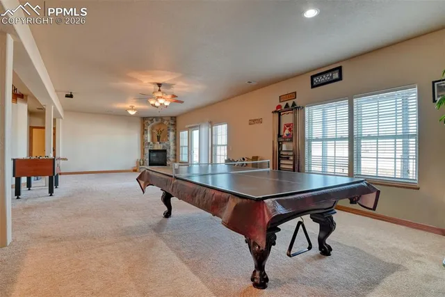 a room with furniture pool table table tennis table and windows