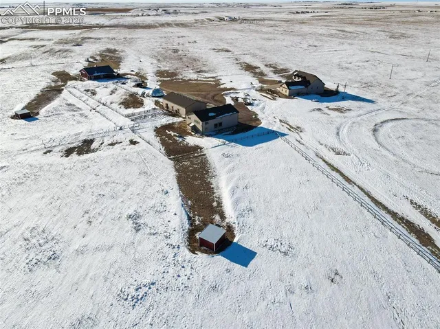 a bed with white sheets and a blanket