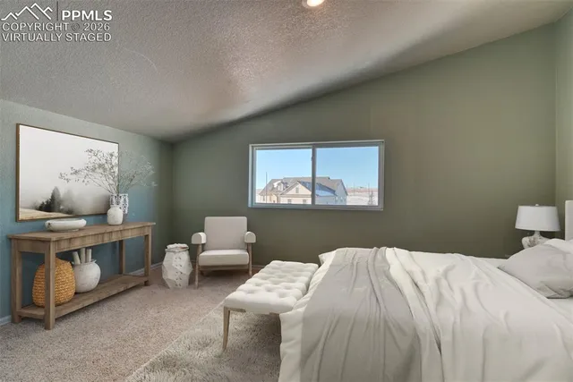 a bedroom with a bed and window