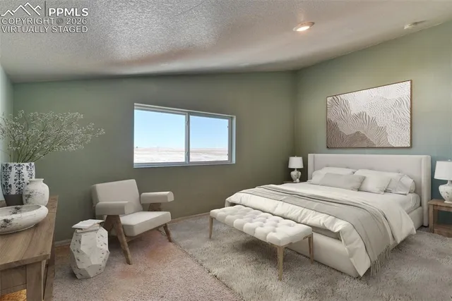 a bedroom with a bed and a couch