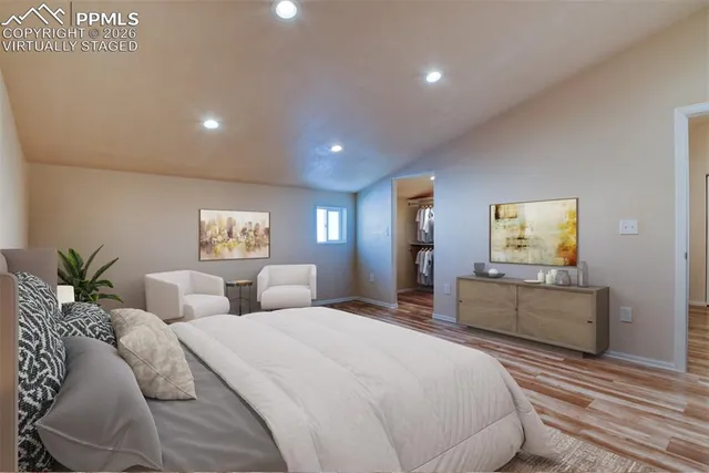 a bedroom with a large bed and a window