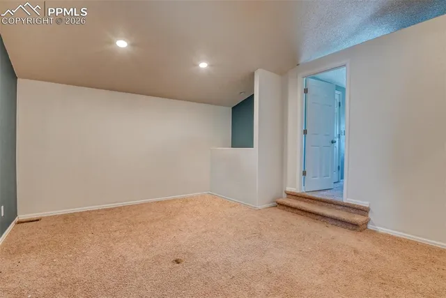 an empty room with painting on the wall