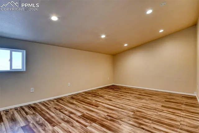 a view of room with wooden floor and fan