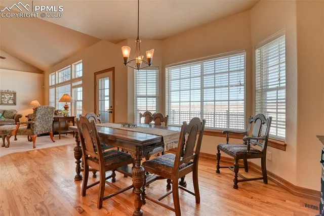 a view of a dining room with furniture window and wooden floor