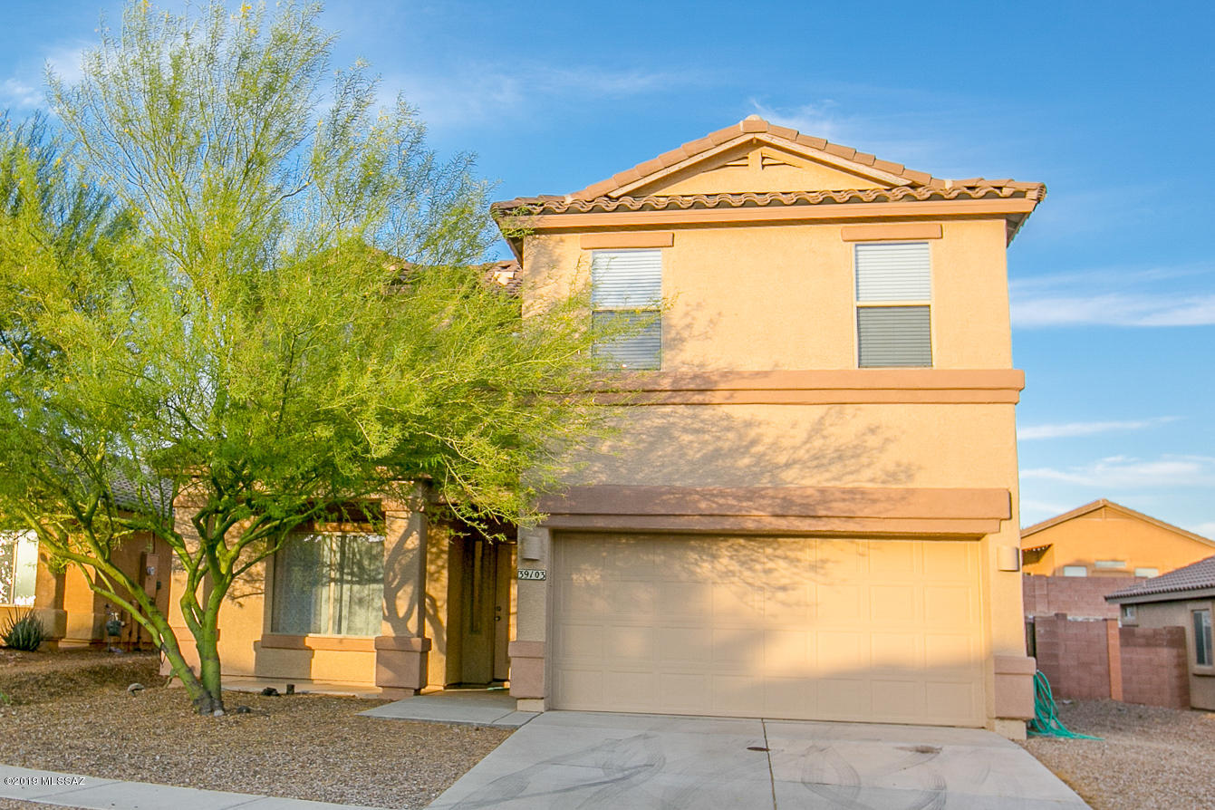 39103 Winners Circle Tucson, AZ 85739 - Photo 1 of 19 a front view of a house with a yard