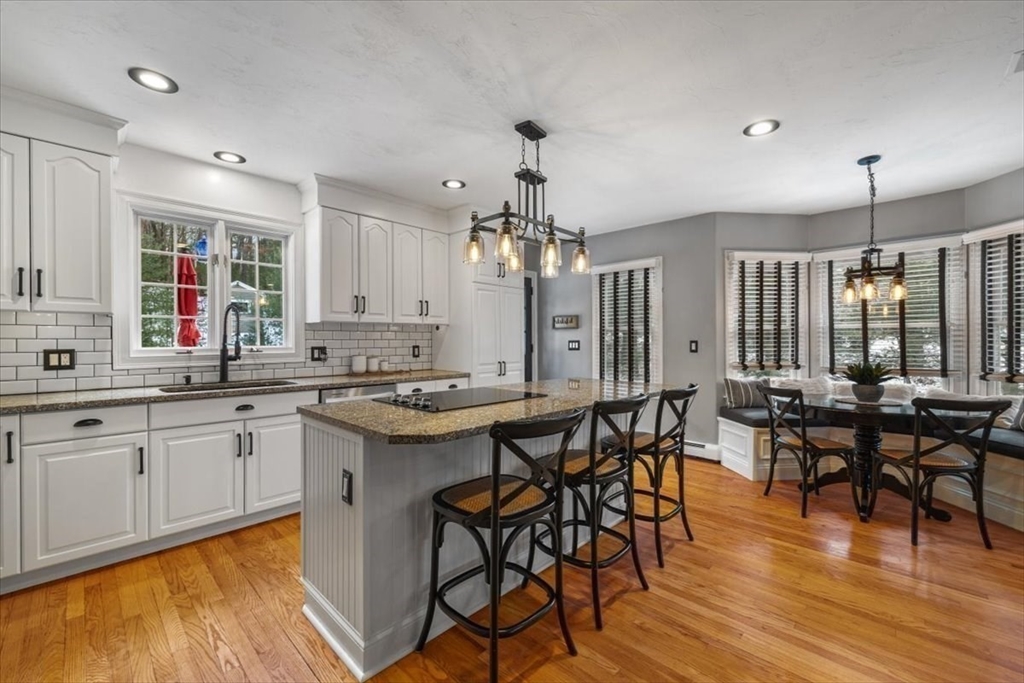 31 Round Hill Road Kingston, MA 02364 - Photo 11 of 42 a kitchen with center island table and chairs in it