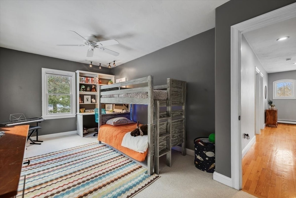 31 Round Hill Road Kingston, MA 02364 - Photo 31 of 42 a bedroom with furniture and a chandelier