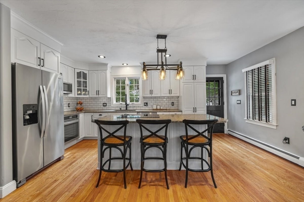 31 Round Hill Road Kingston, MA 02364 - Photo 10 of 42 a kitchen with stainless steel appliances a dining table chairs refrigerator and microwave